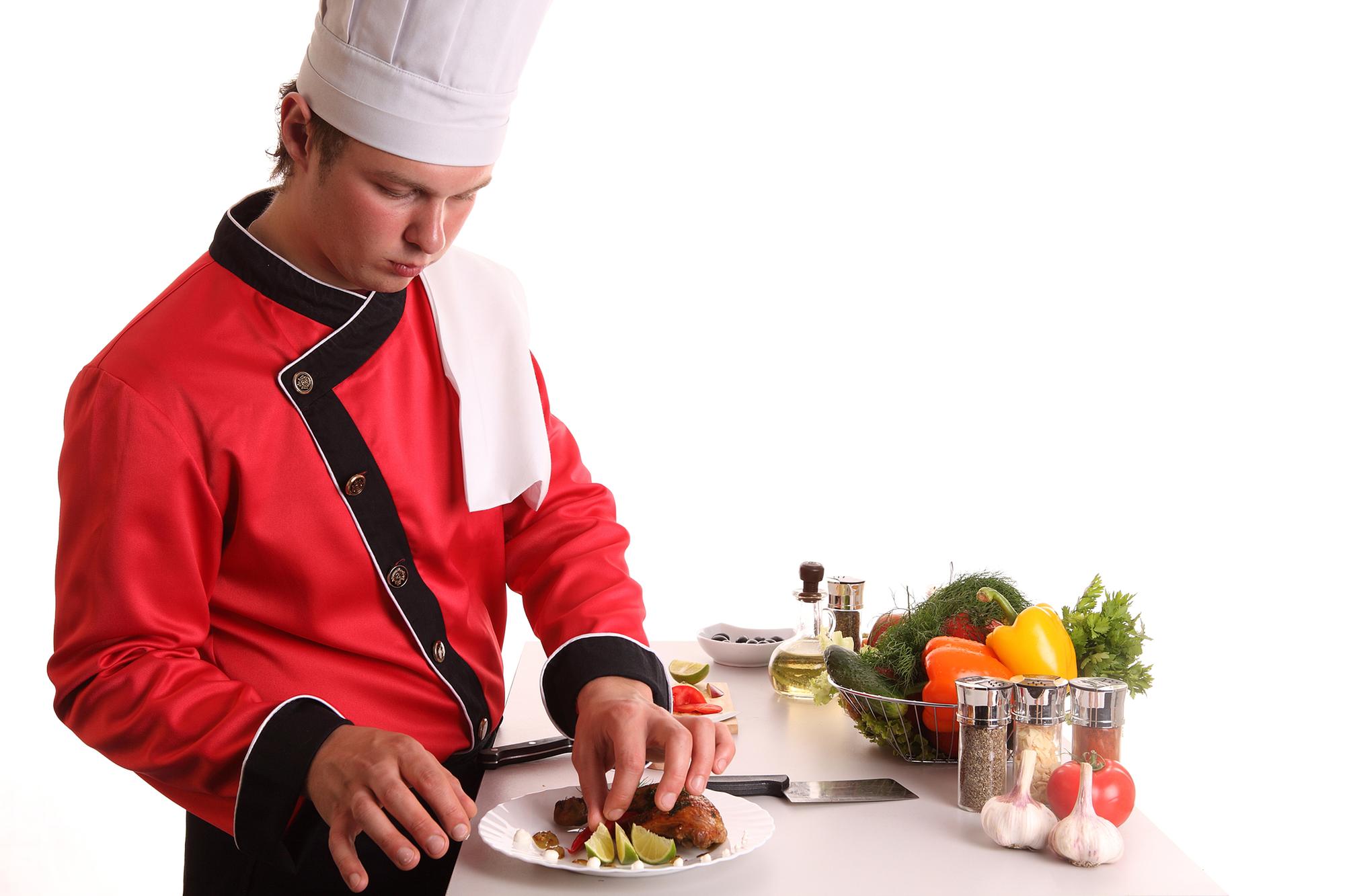 Instructor demonstrating a colorful dish in a bright kitchen